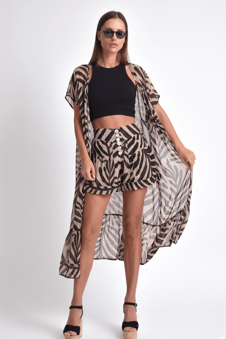 Woman wearing a zebra print outfit with a black top on a white background