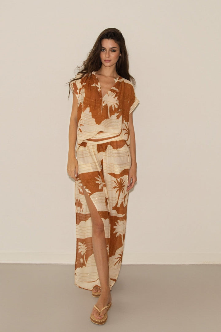 Woman wearing a floral dress with a plain background