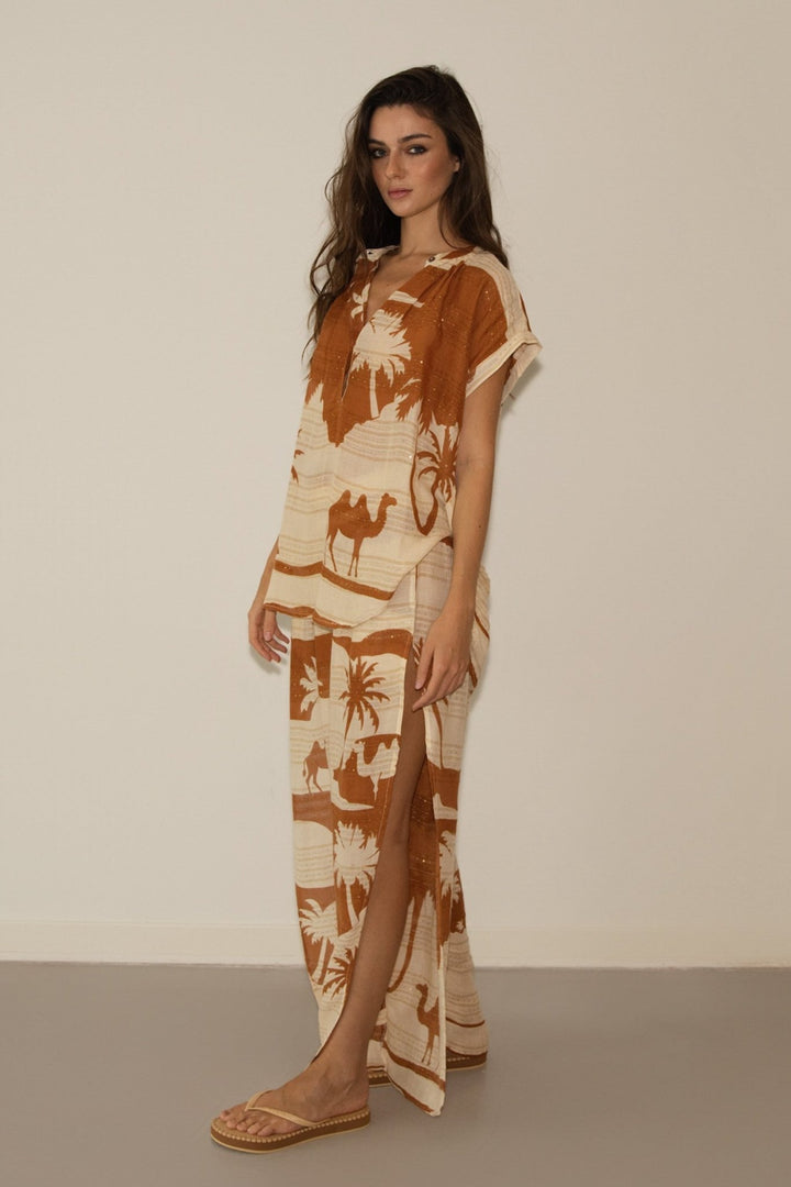 Woman wearing a patterned dress with a neutral background