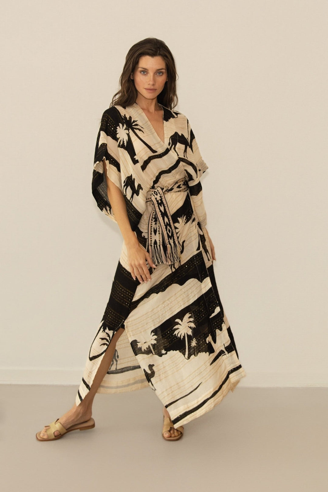 Woman wearing a black and white patterned dress against a plain background