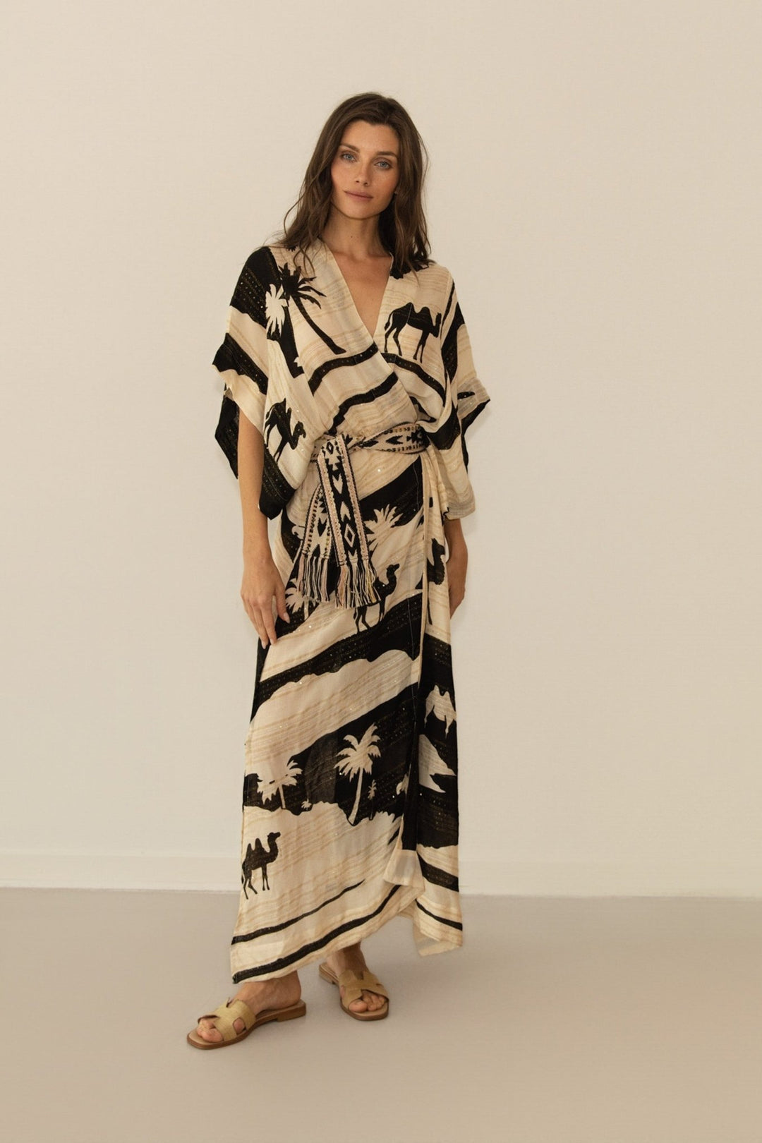 Woman wearing a black and white patterned dress against a plain background