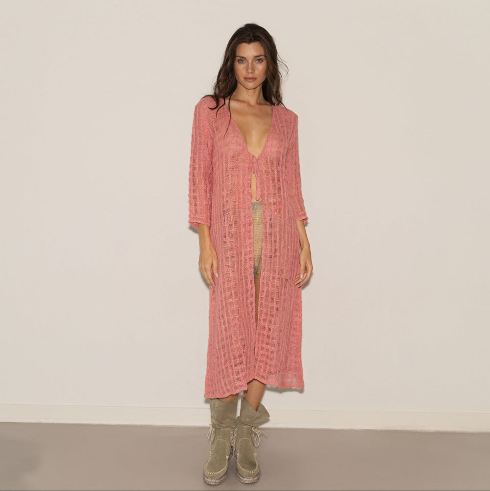 Woman wearing a pink dress with a white background