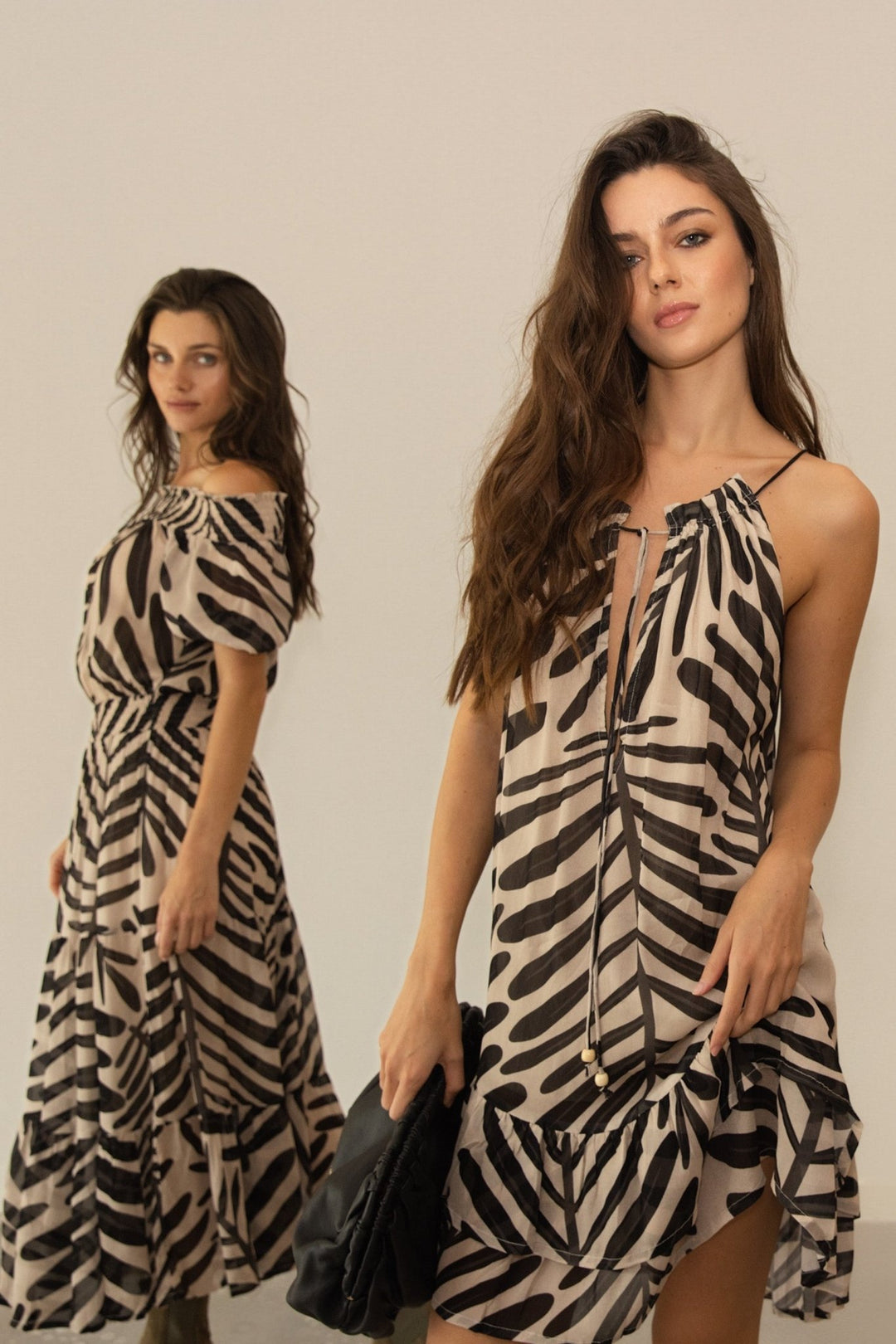 Woman wearing a zebra print dress against a plain background