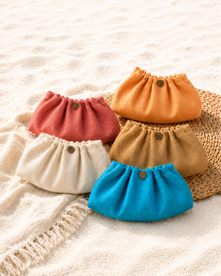 Set of colorful drawstring bags on a textured surface